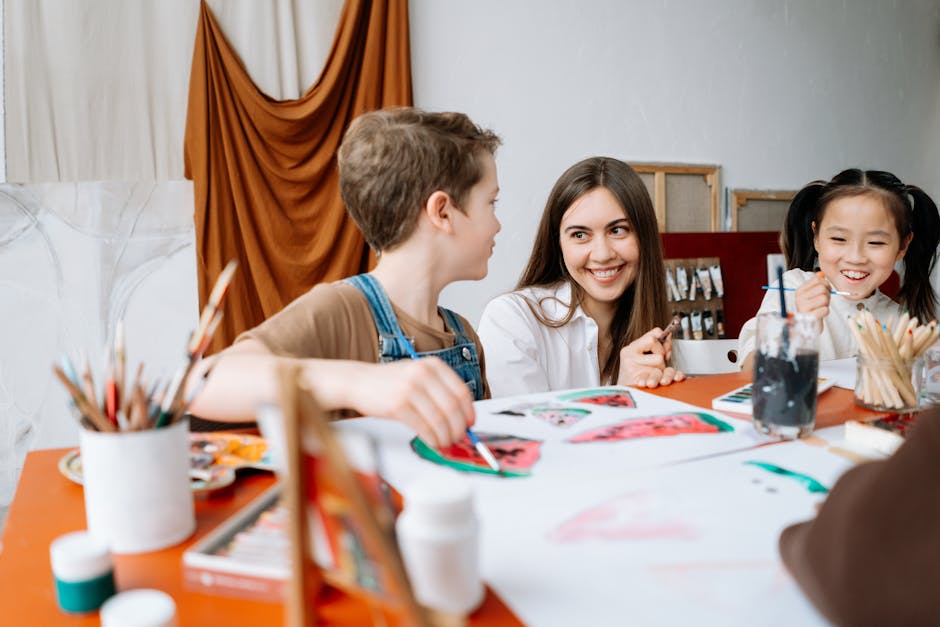 Children and teacher engaged in a fun art workshop, painting and smiling indoors.