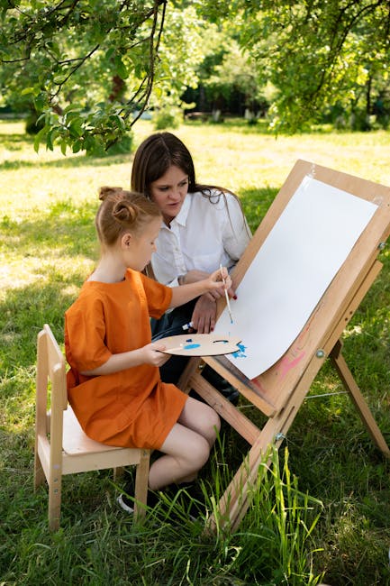 A child learning to paint with a teacher outdoors on a sunny day, capturing creativity and leisure.