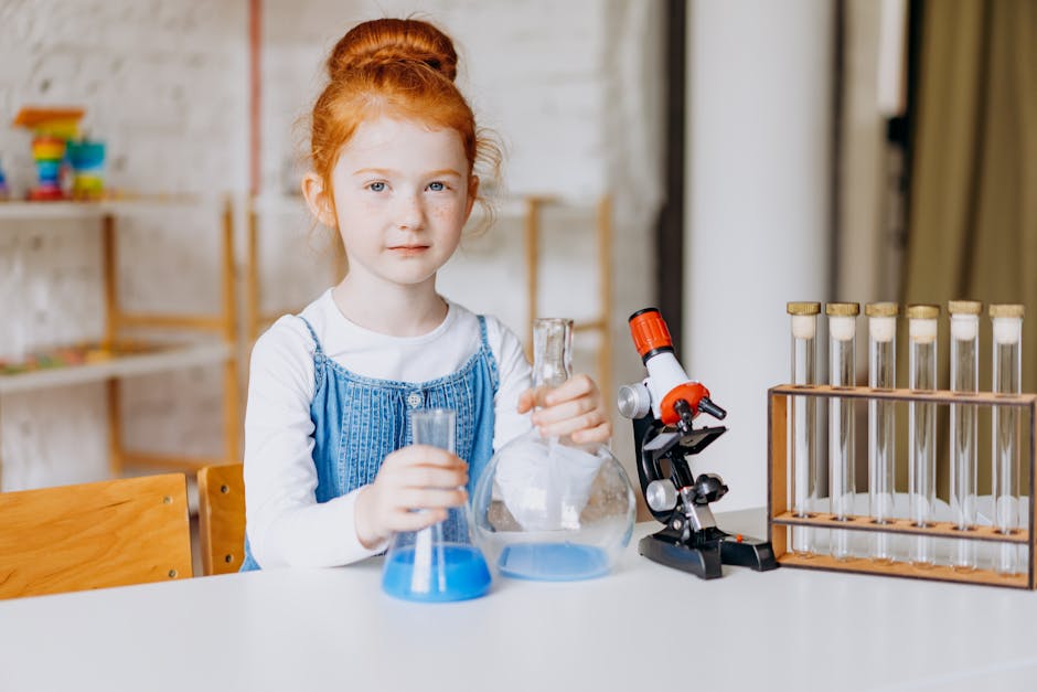 A young girl is engaged in a fun science experiment indoors, learning with flasks and a microscope.